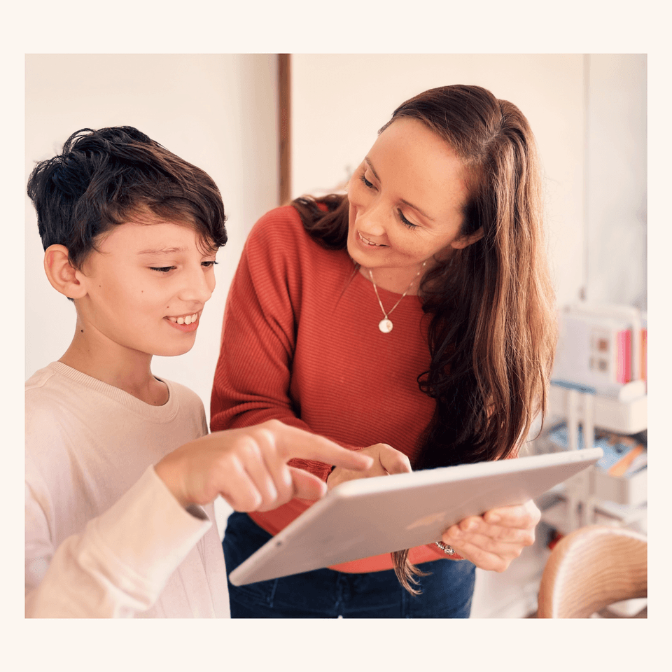 A home educator and child learning together with a tablet