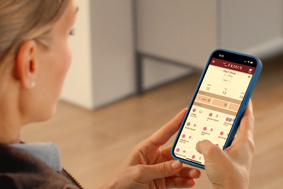 Woman using My Week in Freely homeschool tracking app